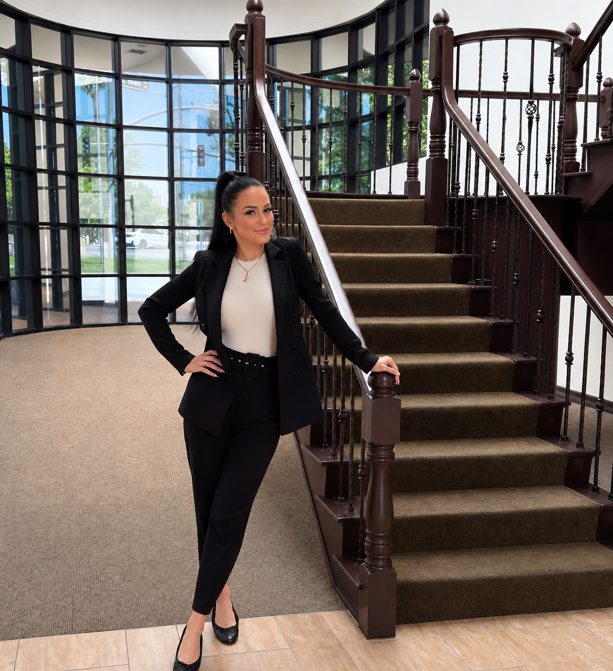 Emma Charlotte, book marketing expert, posing by a staircase